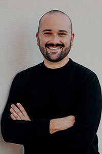 bald man wearing a black sweater