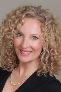 woman with curly blonde hair and blue eyes
