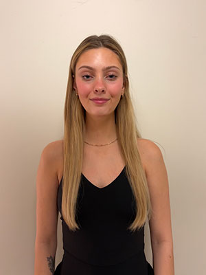 white woman with long blonde hair wearing a black dress