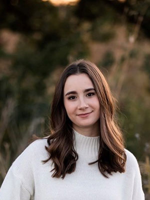 Master of Public Administration degree student: White brunette female wearinga a white sweater