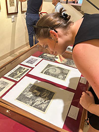 Busso looking at prints