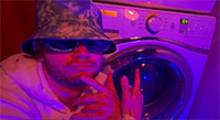 man posing in front of washing machine