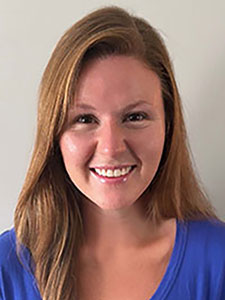 smiling woman with dark hair wearing blue shirt