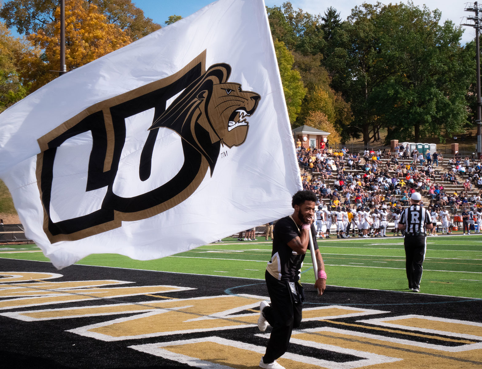 Homecoming 2024 - Student with LU banner.