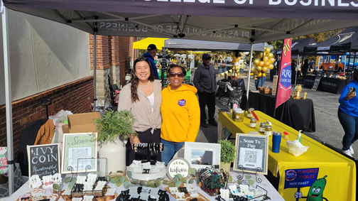 Ashley Shoemake and Sherrese Hester standing in their booth