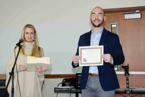 Cody Copeland&nbsp;is awarded First Place in his Poster Group at the Social Science Student Symposium (November 10, 2018)&nbsp;by Assistant Dean of the School of Sciences, Dr. Billi Patzius.